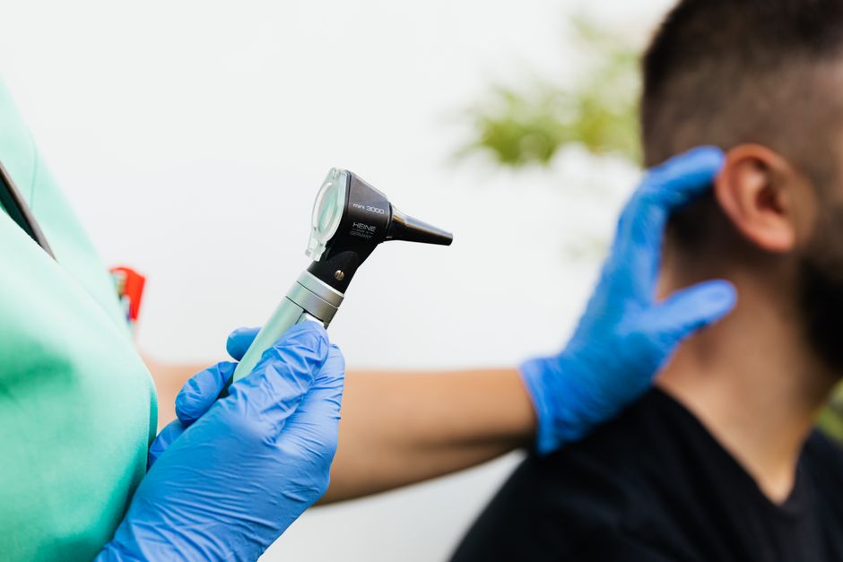 Audiologist examining a patient