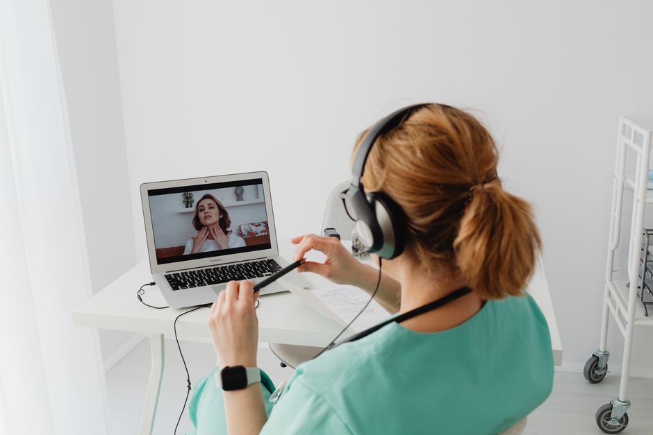 Doctor on a laptop during an online doctor visit that a patient is paying for without insurance